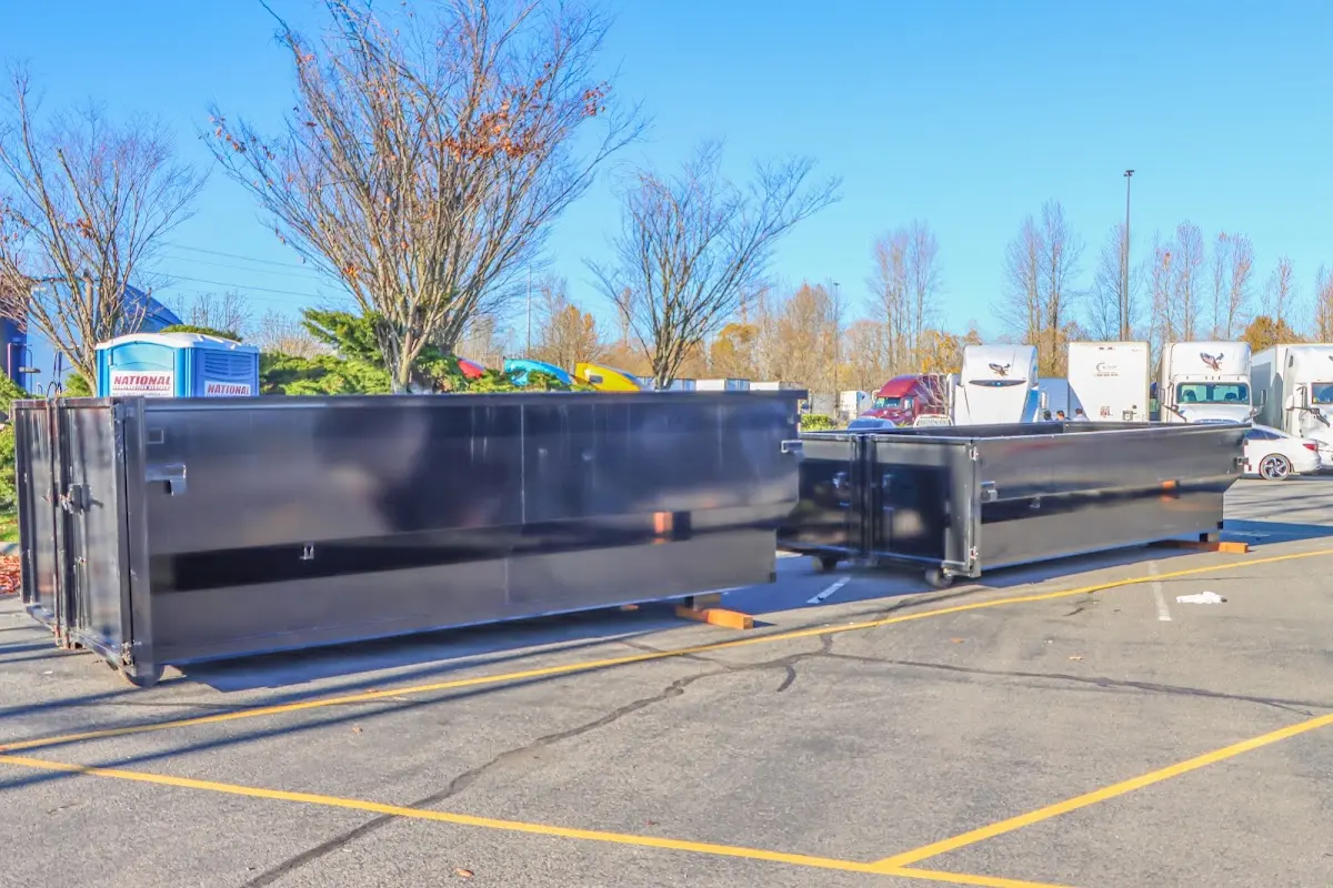 Professional dumpster rental service with roll-off container on residential driveway in Newington